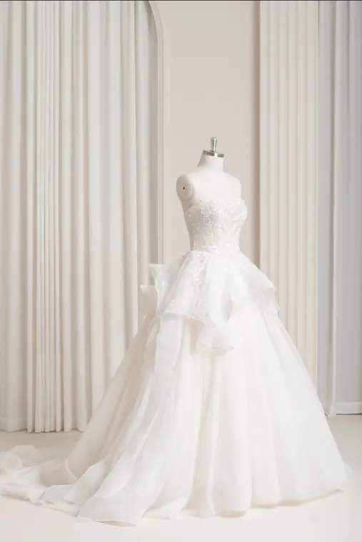 Ophelia: Delicately embellished strapless gown with cascading sculptural organza-like waist detailing, front view