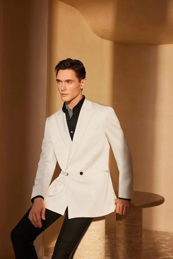 Afterglow: Ivory jacket with black open collar and black trousers, editorial inspiration reference photograph