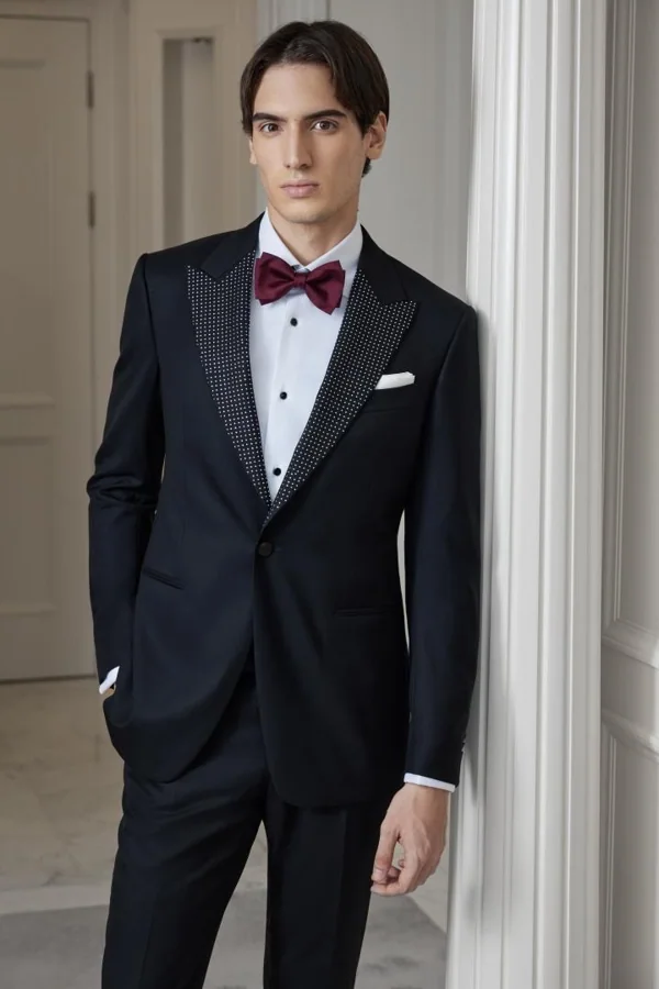 Burgundy Constellation: Black embellished-lapel tuxedo with burgundy bow, editorial inspiration reference photograph